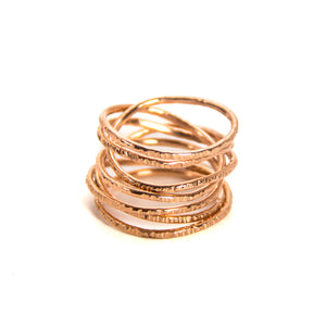 hammered coil rings in golds and silver